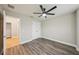 Neutral bedroom with a ceiling fan, wood-look floors, and double closet at 1846 Galloway Ter, Winter Haven, FL 33881