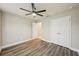 Neutral bedroom with a ceiling fan, wood-look floors, and double closet at 1846 Galloway Ter, Winter Haven, FL 33881