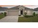 Charming single-story home with a two-car garage and a well-manicured front yard at dusk at 1846 Galloway Ter, Winter Haven, FL 33881