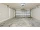 Spacious empty garage with a concrete floor and a white garage door at 1846 Galloway Ter, Winter Haven, FL 33881
