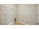 Compact laundry room with tile floors, wire shelf and hookups for washer/dryer at 1846 Galloway Ter, Winter Haven, FL 33881