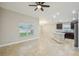 Spacious living room with ceramic tile flooring, a ceiling fan, and abundant natural light at 1846 Galloway Ter, Winter Haven, FL 33881