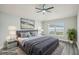 A stylish main bedroom is virtually staged, showing a comfortable bed, ceiling fan, and ample light at 1846 Galloway Ter, Winter Haven, FL 33881