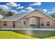 A spacious backyard and home exterior with a well-manicured lawn and ample natural light at 1940 Southern Dunes Blvd, Haines City, FL 33844
