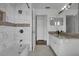 This well-lit bathroom features marble-look tile, granite counters, and a shower-tub combo with a neutral palette at 1940 Southern Dunes Blvd, Haines City, FL 33844