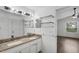 Bright bathroom featuring double sinks, granite counters, and ample storage space with an open doorway at 1940 Southern Dunes Blvd, Haines City, FL 33844