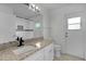 The spacious bathroom boasts granite counters, a single vanity, and tiled floors at 1940 Southern Dunes Blvd, Haines City, FL 33844