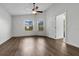Bright and airy bedroom with hardwood floors, a ceiling fan, and two large windows at 1940 Southern Dunes Blvd, Haines City, FL 33844