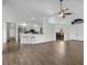 Open-concept living space with hardwood floors, breakfast bar, and views into the dining room at 1940 Southern Dunes Blvd, Haines City, FL 33844
