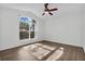 The bright living room features wood-look floors and a large arched window with natural light at 1940 Southern Dunes Blvd, Haines City, FL 33844