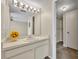 Bathroom featuring a single sink vanity, great lighting, neutral paint, and a walk-in closet at 200 Saint Andrews Blvd # 1603, Winter Park, FL 32792
