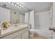 Bathroom with a white vanity, large mirror, and a bathtub with a shower curtain at 200 Saint Andrews Blvd # 1603, Winter Park, FL 32792