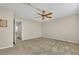 A bright bedroom featuring neutral walls, carpeted flooring, and a classic ceiling fan at 200 Saint Andrews Blvd # 1603, Winter Park, FL 32792