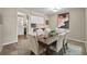 Dining room features a rustic wood table, six chairs, neutral walls and unique painting at 200 Saint Andrews Blvd # 1603, Winter Park, FL 32792