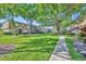 Exterior view showcasing the lush landscaping and mature trees surrounding the condo buildings at 200 Saint Andrews Blvd # 1603, Winter Park, FL 32792