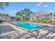 Outdoor pool with lounge chairs and well-maintained landscaping at the Four Seasons Condominiums at 200 Saint Andrews Blvd # 1603, Winter Park, FL 32792