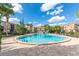 Community pool with clear blue water, surrounded by condo buildings and lush greenery at 200 Saint Andrews Blvd # 1603, Winter Park, FL 32792