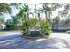 Entrance to Four Seasons Condominiums with lush tropical landscaping around the sign at 200 Saint Andrews Blvd # 1603, Winter Park, FL 32792