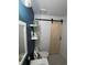 Chic bathroom featuring a sliding barn door, accent wall, and modern fixtures for a stylish retreat at 2035 Dixie Belle Dr # 2035C, Orlando, FL 32812