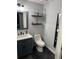 Well-maintained bathroom featuring floating shelves and tiled floors at 2035 Dixie Belle Dr # 2035C, Orlando, FL 32812