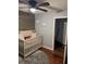 Bedroom featuring hardwood floors, a crib, dresser, cute cloud nightlights and an open doorway at 2035 Dixie Belle Dr # 2035C, Orlando, FL 32812