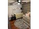A charming Bedroom featuring hardwood floors, crib, dresser and a modern ceiling fan at 2035 Dixie Belle Dr # 2035C, Orlando, FL 32812