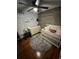 A charming Bedroom featuring hardwood floors, crib, dresser and a modern ceiling fan at 2035 Dixie Belle Dr # 2035C, Orlando, FL 32812