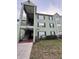 Exterior view of a light green two-story condo building with a stairway and black shutters at 2035 Dixie Belle Dr # 2035C, Orlando, FL 32812
