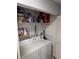 Functional laundry area with a washing machine, dryer, and convenient overhead shelving for storage solutions at 2035 Dixie Belle Dr # 2035C, Orlando, FL 32812