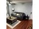 Living room featuring hardwood floors, a ceiling fan, seating arrangement and access to front door at 2035 Dixie Belle Dr # 2035C, Orlando, FL 32812