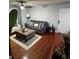 Living room featuring hardwood floors, a ceiling fan, seating arrangement and access to front door at 2035 Dixie Belle Dr # 2035C, Orlando, FL 32812