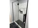 Modern glass-enclosed shower featuring subway tile walls, black fixtures, and a stylish black hexagon tile floor at 2035 Dixie Belle Dr # 2035C, Orlando, FL 32812