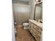 Bathroom featuring a vanity with drawers, a white sink, and a decorative mirror at 2464 Lotafun Ave, Winter Park, FL 32789
