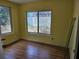 Bedroom with laminate floors, a large window, and neutral walls at 2464 Lotafun Ave, Winter Park, FL 32789