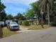Exterior view of home with mature trees, landscaping, and a gray truck in the driveway at 2464 Lotafun Ave, Winter Park, FL 32789