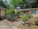 Charming home entrance surrounded by lush landscaping and decorative potted plants at 2464 Lotafun Ave, Winter Park, FL 32789