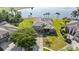 Aerial view of home showing lawn, mature trees, and lakefront views at 2770 Windsorgate Ln, Orlando, FL 32828
