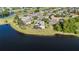 Aerial view of home by lake and golf course, with large lush lawn and mature landscaping at 2770 Windsorgate Ln, Orlando, FL 32828
