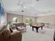 Spacious basement with a pool table, ping pong table, and comfortable seating area for entertainment and relaxation at 2770 Windsorgate Ln, Orlando, FL 32828