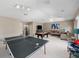 Finished basement with ping pong and pool table, seating, and entertainment options, enhancing the home's leisure potential at 2770 Windsorgate Ln, Orlando, FL 32828