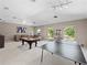 Versatile basement with a pool table, ping pong table, and cozy seating, perfect for Gathering fun and entertaining guests at 2770 Windsorgate Ln, Orlando, FL 32828
