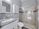 Updated bathroom with granite countertop, decorative mirror, shower with a glass door and neutral color palette at 2770 Windsorgate Ln, Orlando, FL 32828