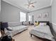 Shared bedroom featuring two twin beds, ample closet space, and a ceiling fan at 2770 Windsorgate Ln, Orlando, FL 32828