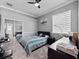 Well-lit bedroom with a modern design, closet, and comfortable furnishings at 2770 Windsorgate Ln, Orlando, FL 32828