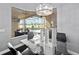 Dining area featuring a view of the pool, lanai, and lake beyond at 2770 Windsorgate Ln, Orlando, FL 32828