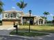 Attractive two-story home with a well-manicured lawn, neutral stone facade, and a three car garage at 2770 Windsorgate Ln, Orlando, FL 32828