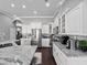 Open kitchen with stainless steel appliances, granite countertops and views into the dining room at 2770 Windsorgate Ln, Orlando, FL 32828