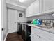 Well-organized laundry room with modern appliances, granite countertops, and ample cabinet space at 2770 Windsorgate Ln, Orlando, FL 32828
