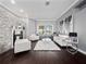 Bright living room featuring a cozy fireplace, white sofas, and decorative artwork at 2770 Windsorgate Ln, Orlando, FL 32828