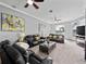 Spacious living room features plush seating, ceiling fans, and large windows at 2770 Windsorgate Ln, Orlando, FL 32828